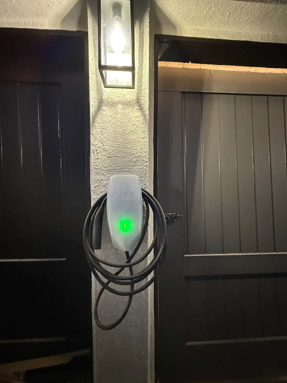 A Tesla Wall Connector installed and charging by Genius Electric Corp in the Antelope Valley